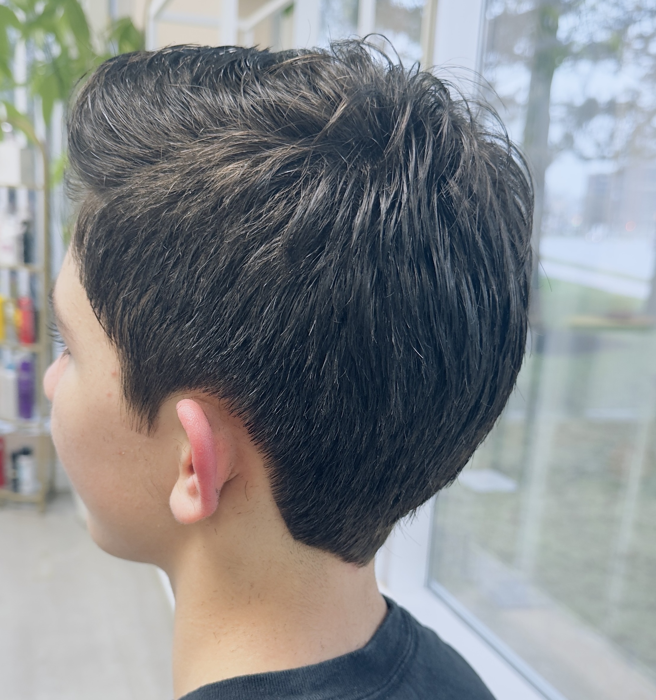 Happy child getting a haircut at HB Beauty salon