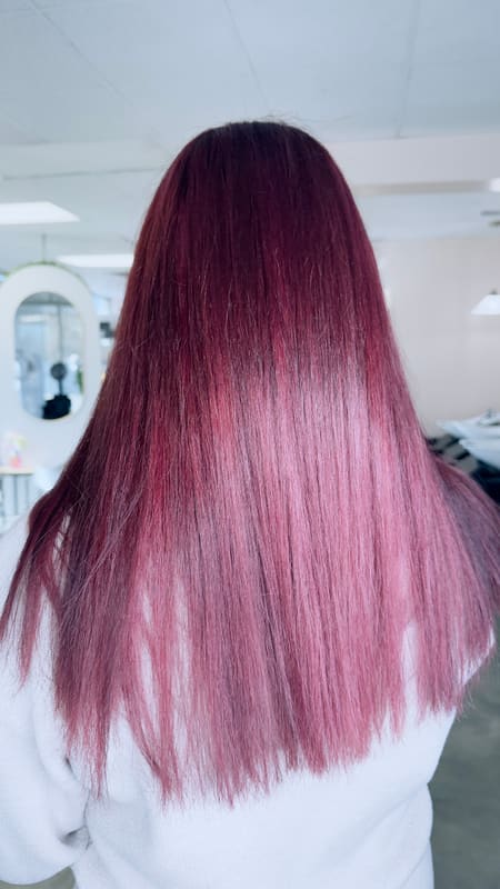 Smooth, straight rose-toned hair after a keratin treatment