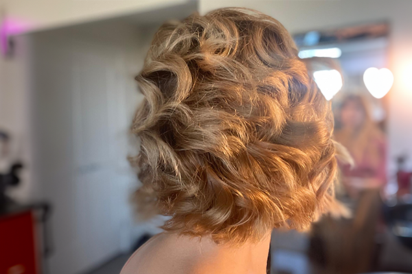 Client receiving professional short hair styling at HB Beauty salon in Kitchener-Waterloo, showcasing textured finish and modern shape